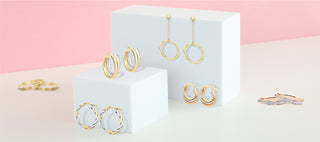 gold hoops on block with pink back ground